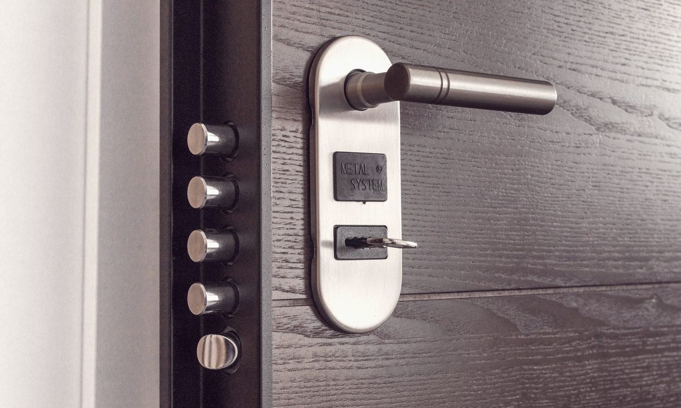 The edge of an open door showing steel multipoint bolts and a keyed euro cylinder.
